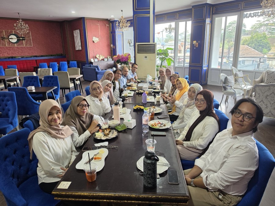 Group members gathered around a long table for the farewell and welcome party